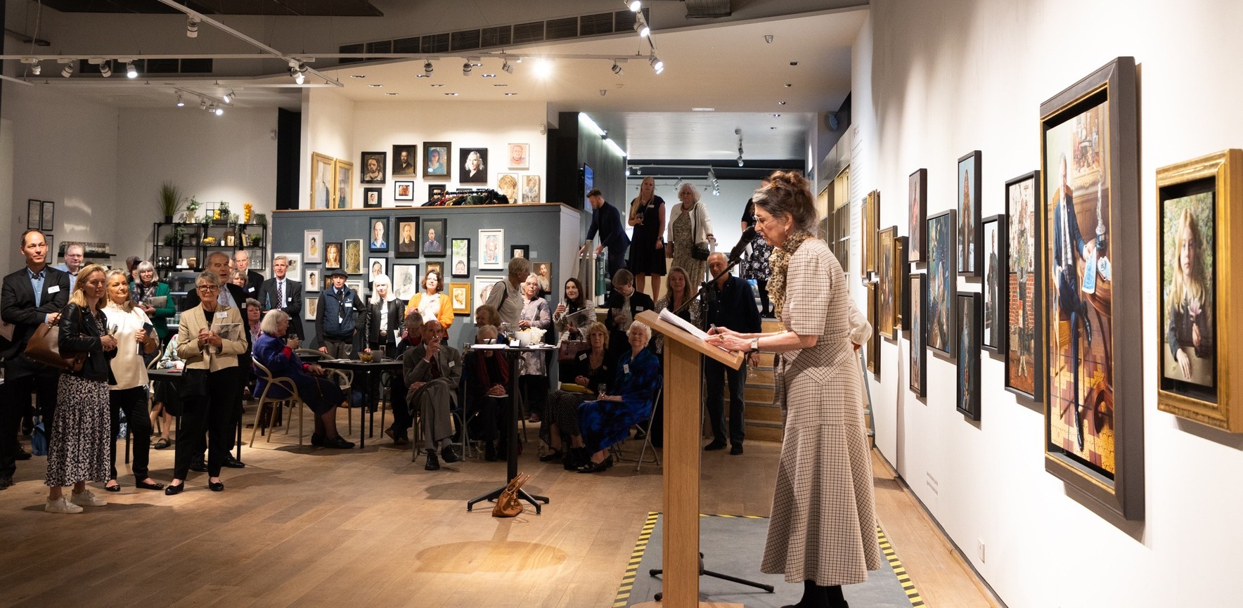 Dame Marina Warner speaks to guests at the Mall Galleries